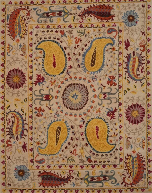 Cream rug with vibrant yellow, rust, and blue floral and large paisley medallions.