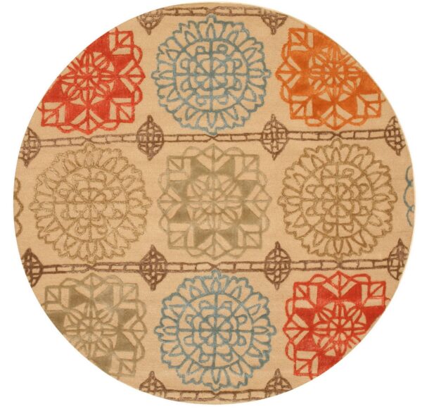 Round tan rug featuring red, blue, and gold stylized floral patterns with a carved pile.