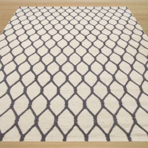 A cream-colored textured rug featuring a dark gray trellis pattern is centered on light wood plank flooring.