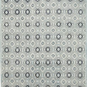 Light gray rug with a repeating geometric trellis pattern featuring dark navy star motifs and light blue accents.