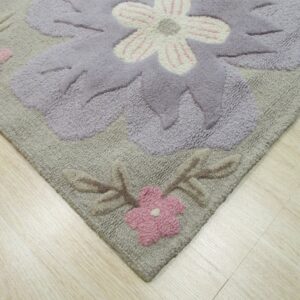 High-pile rug with large carved lavender and pink flowers lies on light wood flooring.