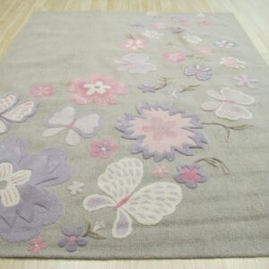 Light gray rug with carved pink and lavender floral and butterfly patterns on light wood planks.