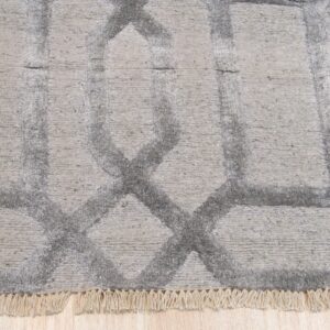 Textured high-low gray rug displaying a large interlocking diamond pattern on light wood flooring.