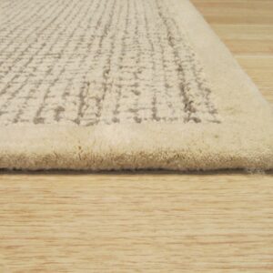 Textured high-pile rug in off-white featuring a raised grid pattern on light wood floorboards.