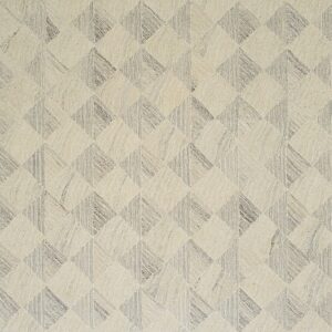 A textured rug with an interlocking geometric pattern in cream and gray tones.