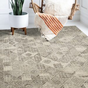 Highly textured neutral rug with geometric patterns displayed in a bright room beside a wicker chair and potted plant.