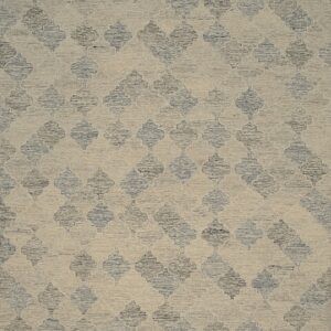 A textured rug featuring a beige ground and repeating dark blue-grey quatrefoil pattern.