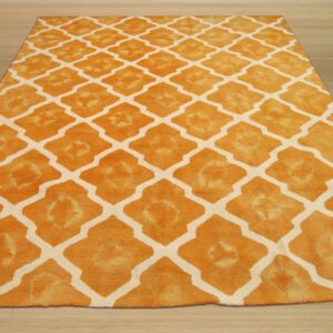 High pile orange rug featuring a geometric cream lattice design, displayed on light wooden floorboards.