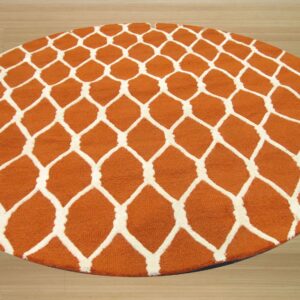 Round orange rug with a raised white geometric trellis pattern sits on light wood flooring.
