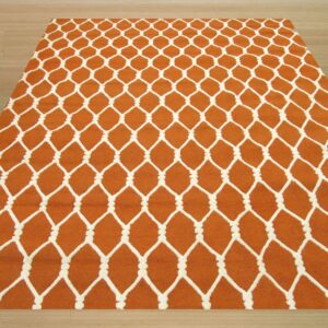 Orange rug with a chunky white knotted lattice pattern on light wood flooring.