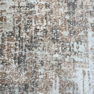 Abstract low pile rug texture blending cream, brown, and charcoal gray colors in a distressed design.