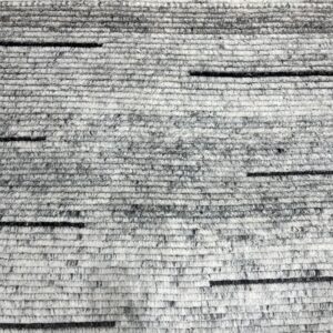 Chunky gray texture rug with heathered horizontal bands and scattered short black accents.