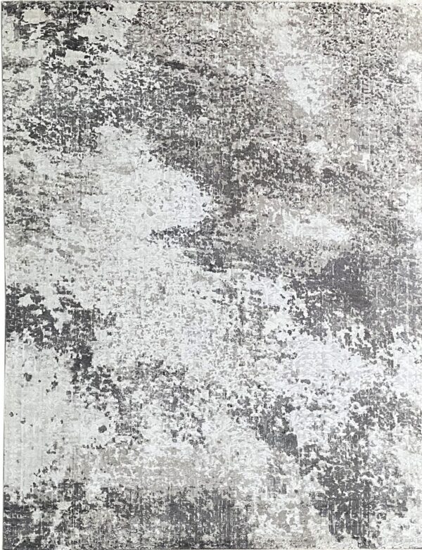 Abstract low-pile rug featuring a distressed, mottled pattern in shades of dark gray, light gray, and white.