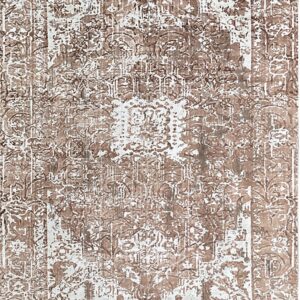 Brown and white high-contrast rug with an abstract, distressed traditional medallion and border design.
