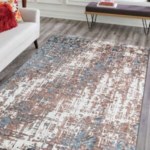 Abstract blue, brown, and white rug with visible texture on gray wood flooring in a bright living room.