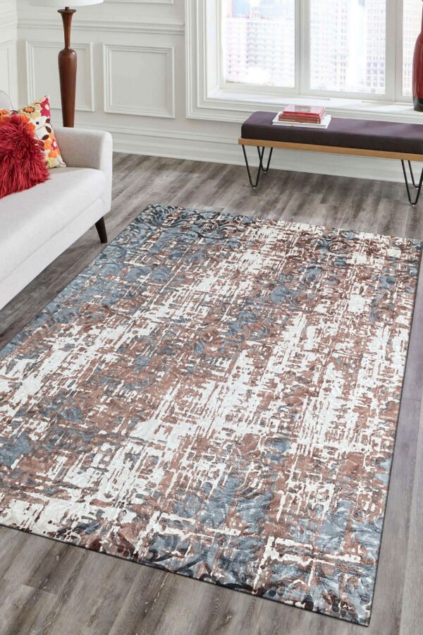 Abstract blue, brown, and white rug with visible texture on gray wood flooring in a bright living room.