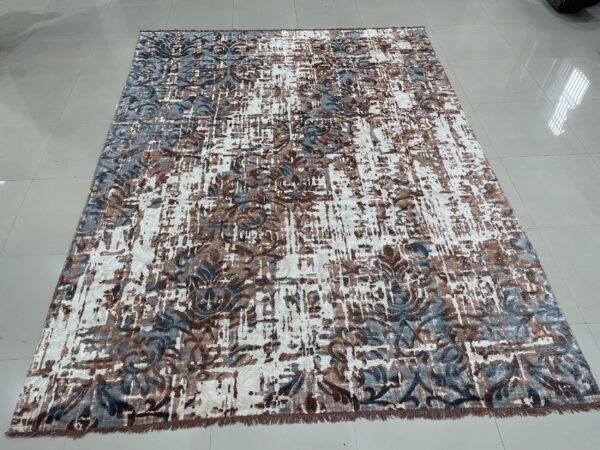 Abstract low-pile rug with white, brown, and blue-gray distressed floral patterns on glossy white tile flooring.