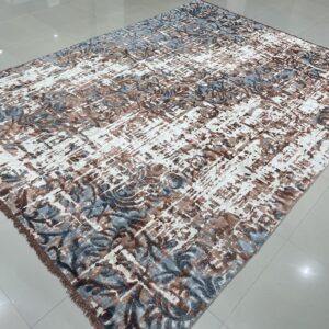 Abstract rug featuring white, brown, and blue-gray patterns, displayed on glossy light gray tile flooring.
