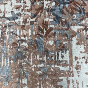 Ribbed texture rug in an abstract pattern of white, brown, and slate blue.