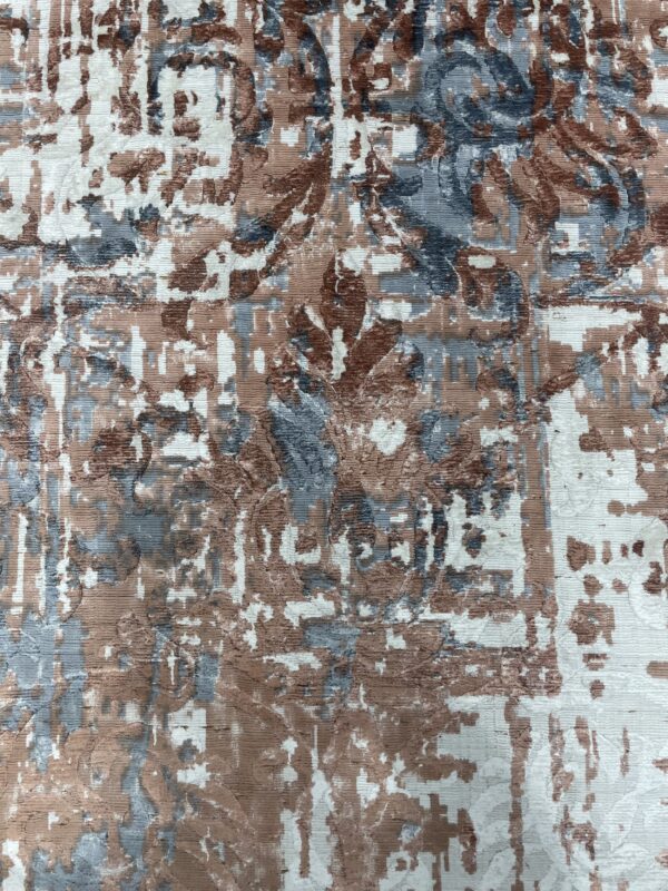 Ribbed texture rug in an abstract pattern of white, brown, and slate blue.