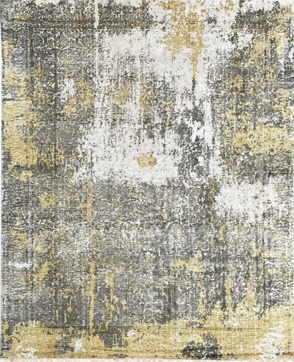 Low pile rug featuring an abstract, distressed pattern in gold, white, and gray with fringe.
