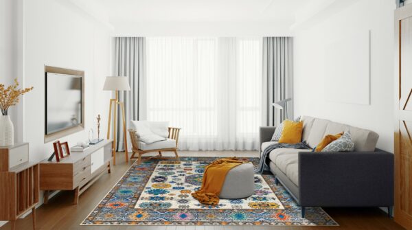 A multicolor patterned rug with blue, orange, and cream anchors a bright living room with a gray sofa.