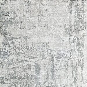 Neutral gray and white low-pile area rug featuring a highly distressed abstract pattern and short fringe.