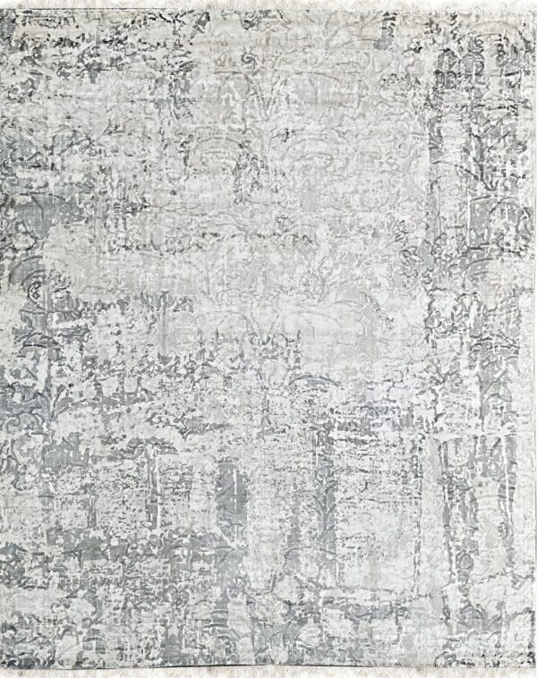 Neutral gray and white low-pile area rug featuring a highly distressed abstract pattern and short fringe.