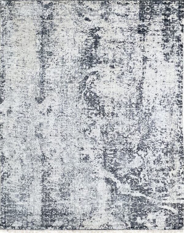 Rectangular low-pile rug with a mottled abstract design in shades of dark gray and white.