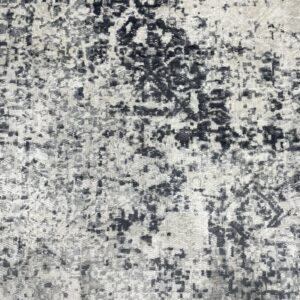 Textured high-low pile rug featuring a heavily distressed abstract pattern in black and light gray tones.