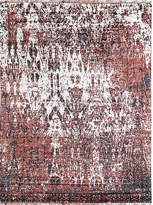 Distressed rug with an abstract pattern in white, terracotta, and dark gray, including fringe edges.