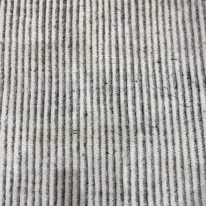 Textured high-pile rug featuring thick vertical stripes alternating in mottled gray and creamy white.