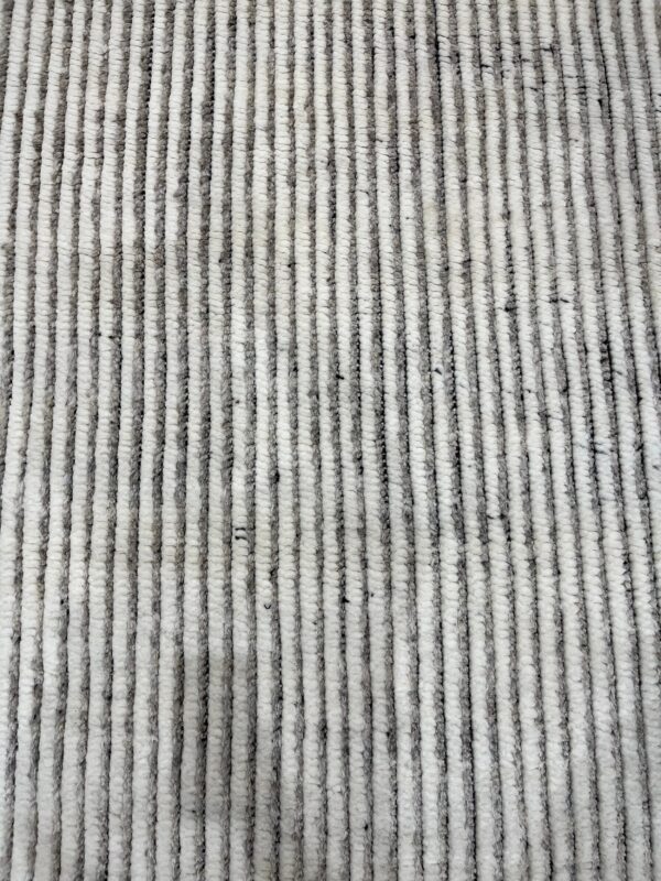 Textured high-pile rug featuring thick vertical stripes alternating in mottled gray and creamy white.