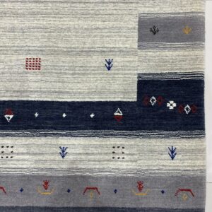 Gray, navy, and white striped area rug with textured pile and scattered red and yellow geometric patterns.