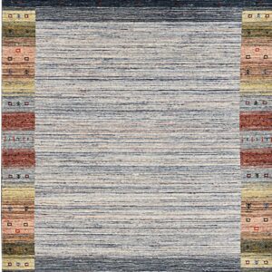 The rug has a striated blue-gray center field framed by dark navy borders and multi-colored patterned side panels.