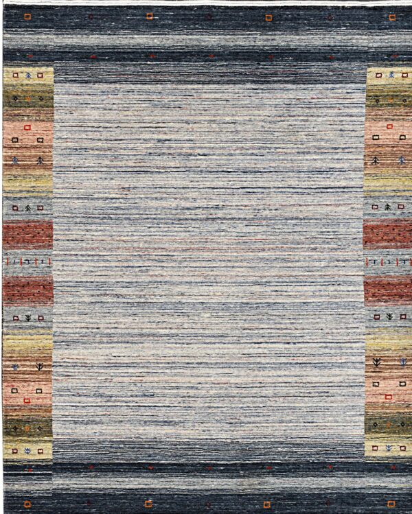 The rug has a striated blue-gray center field framed by dark navy borders and multi-colored patterned side panels.