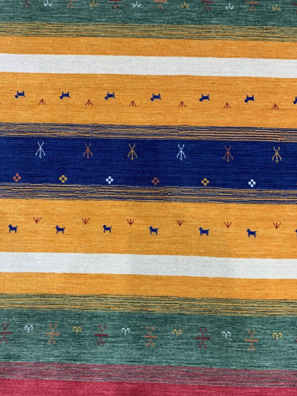 Horizontal striped rug in mustard, white, navy, and teal, decorated with tiny stylized animal and geometric motifs.