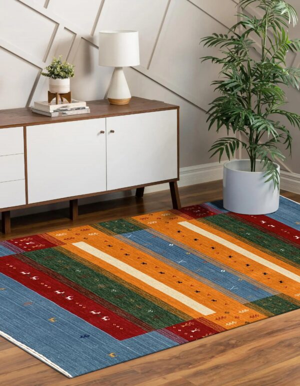 Multicolored striped rug rests on wood flooring below a mid-century modern white console cabinet.