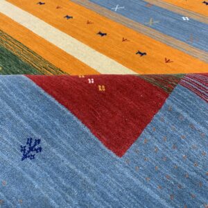 Multicolored striped rug featuring orange, blue, red, and green panels with scattered small geometric motifs.