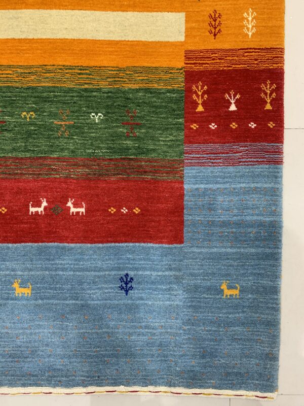 Bright blue, red, green, and orange rug blocks decorated with stylized animal and abstract figures.