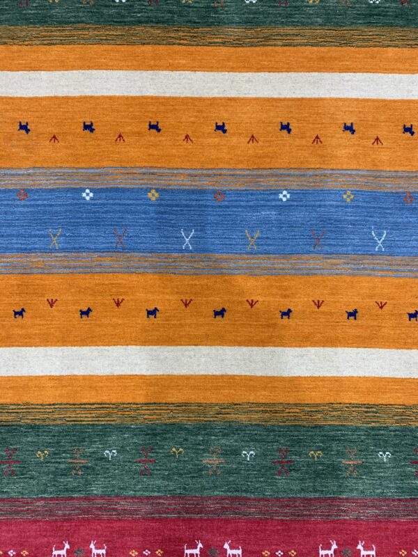 Low pile rug featuring horizontal stripes in orange, blue, green, and red with stylized figures.