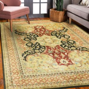 Gold, red, and black ornate traditional rug on wood floor with pink and gray furniture nearby.