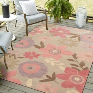 Large pink and purple floral rug on a gray wooden deck near two cushioned patio chairs.