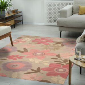 Tan floral area rug with large pink and mauve designs defines a modern living room space.