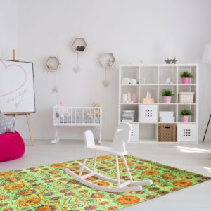 A bright lime green and orange distressed rug sits under a white rocking horse in a modern nursery.