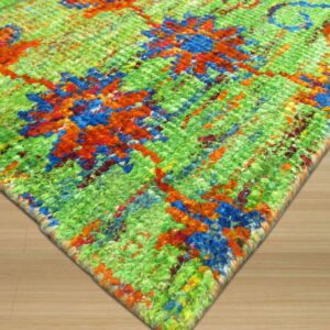 Vibrant, textured rug corner featuring green, blue, and orange abstract patterns on light wood flooring.