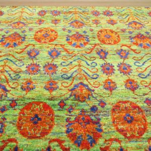 Textured rug in chartreuse green, featuring stylized floral patterns in vibrant orange and blue.