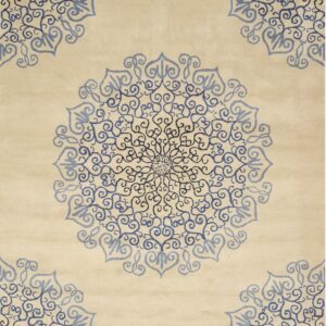 Cream rug featuring ornate blue and dark blue swirling medallion designs.