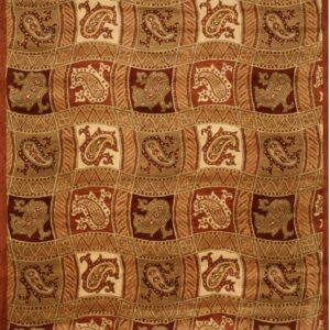 A high-pile rug features a patchwork pattern of paisley motifs in rust, khaki, and cream.