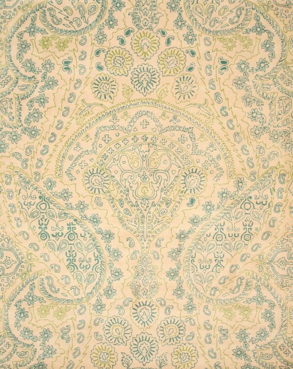 Beige rug featuring a detailed paisley and floral pattern outlined in teal and light green.